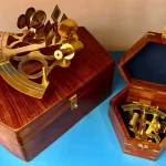 Brass sextants in wooden boxes.